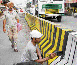 Unperturbed by the rush around him, a painter continues with his work in Ambala.