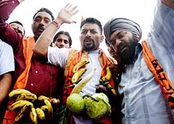 Members of the Shiv Sena (Hindustan) protest against the hike in the prices of vegetables and fruits at Indira Chowk in Jammu