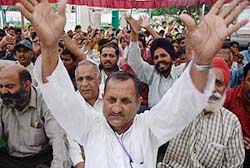 Members of the Jammu and Kashmir Joint Traders Union Committee stage a dharna in Jammu