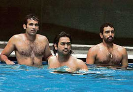 Zaheer Khan (left), Mahendra Singh Dhoni and Robin Uthappa (right) in their hotels swimming pool in Dhaka on Friday.