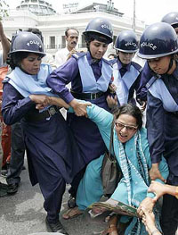 Police detain an opposition supporter during a rally in Lahore on Friday.