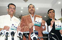 (From right) BJP general secretary Khushi Balnahata, state president Jai Ram Thakur and Ashok Sood release BJP manifesto for the MC elections, in Shimla on Saturday.
