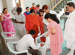Residents of Sector 20 gather to get their pictures clicked for voter identity cards at the community centre in the locality in Panchkula on Sunday.