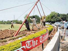 Traffic lights being installed at Tribune Chowk in Chandigarh on Sunday.