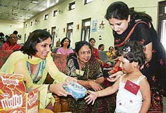 A winner receives a prize in a baby show contest organised by the District Red Cross Society as part of the summer festival in Dharamsala on Sunday.