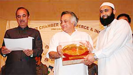 Jammu and Kashmir Chief Minister Ghulam Nabi Azad and union minister of state for commerce Jairam Ramesh give a gift to a Kashmiri at a function in Srinagar.