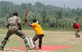Army officers of Rashtriya Rifles play cricket with local Kashmiris at Anantnag.