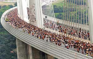 Competitors run across the Millau Viaduct during the "Viaduc" race of 23,550 km from Millau and back, southern France, on Sunday. The Millau Viaduct is composed of seven slender soaring pillars and is the highest bridge in the world at 343 metres, creating a direct route between Paris and the Mediterranean coast.