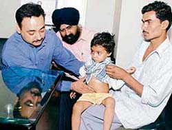 Dr H.S. Jolly examines the child who underwent needloscopy for removal of gall stones at RG Hospital in Ludhiana