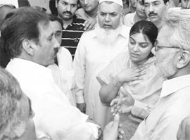 Pakistan's suspended Chief Justice Iftikhar Chaudhry (left) comforts Shadana Raza (centre) widow of Syed Hammad Raza, at her residence in Islamabad on Monday. Gunmen shot dead Raza, a senior official of Pakistan's Supreme Court at his home in Islamabad early on Monday.
