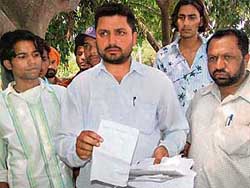 Harbans Lal shows documents relating to the treatment of his wife at the Civil Hospital in Mohali