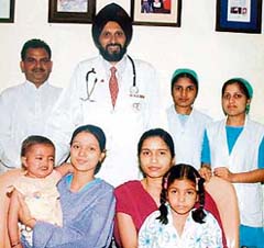Baljinder (left) and Komal with their mothers. Standing behind are Dr H.S. Bedi and members of his team in Ludhiana