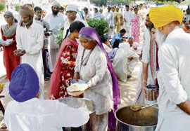 Patients and their attendants being served langar by sewadars of Gurdwara Jhanda Sahib of Padiala village at the PGI, Chandigarh.