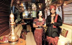 Models greet inside a newly launched luxury bus to promote heritage tourism in the Capital