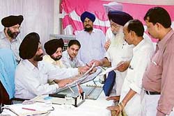 Joint Commissioner M. S. Kainth listens to grievances of people during MC’s sangat darshan programme in Ludhiana