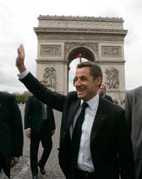 France's new President Nicolas Sarkozy waves to supporters near the Arc De Triomphe in Paris, following the handover ceremony, on Wednesday. 