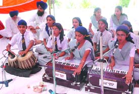 Students of Guru Teg Bahadur Public School present shabd kirtan on schools foundation day at Hazara village in Jalandhar on Thursday. 