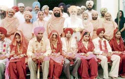 Jagdish Singh Garcha and other leaders pose with newlywed couples at Brahampur village near Ahmedgarh
