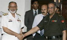 Pakistan's Rear Admiral Tanveer Faiz (left) receives his Indian counterpart Major Gen Gopal Rao for talks on Sir Creek in Rawalpindi on Thursday