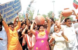 BJP activists protest against water and power shortage at Azadpur Chowk in the Capital