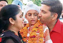 Harish and his wife Manju, after getting custody of their seven-year-old child Amarpratap Singh, outside the court room in Amritsar