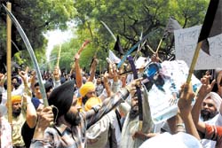 Sikhs brandish swords and raise slogans against the chief of Dera Sacha Sauda Gurmeet Ram Rahim Singh during a protest in the Capital on Sunday