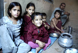 Makhan Khan, who has migrated with his grandchildren, at Talwara near Reasi.