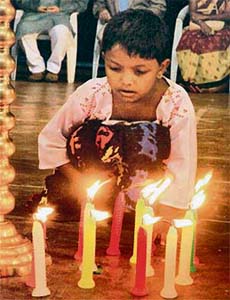 A young girl lights candles "In Remembrance of Lives lost in AIDS" on the occasion of International Candle Light Memorial Day in Kolkata