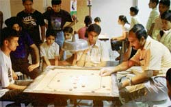 A player aims a shot during a carrom match in the 10th St Stephens Carrom Ranking Tournament at the school in Sector 45, Chandigarh