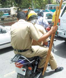 Two policemen ride a motorcycle without a number in the Capital