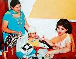 A dentist conducts check-up of a student at Love Dale School in Ludhiana