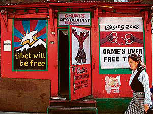 Tibetans use the streets of McLeodganj for a 'poster war' against China. A poster outside a restaurant reflects their protest against the holding of the 2008 Olympics at Beijing.