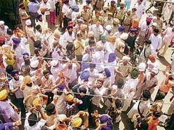 Demonstrators raise slogans and officials watch helplessly at Ahmedgarh during the bandh