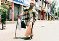 A handicapped beggar looks for alms during the bandh observed in Bathinda
