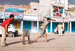 Youngsters enjoy cricket in the main bazar during the Punjab bandh in Bathinda 