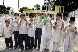 Government schoolchildren fetch drinking water from a gurdwara at Talwara in Reasi as water is not available in the school.