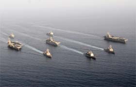 US warships carrying 17,000 personnel enter the Gulf in a show of force off Iran's coast that navy officials said was the largest daytime assembly of ships since the 2003 Iraq war