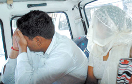 Suspended Congress councillor Veena Saini with husband Naresh Saini being taken to Tis Hazari Courts in the Capital on Thursday. They were arrested on Wednesday by the CBI for demanding bribe.