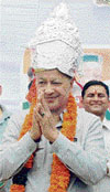 Chief Minister Virbhadra Singh wears a silver crown presented by Congress activists during an election meeting at Dughali on Thursday.