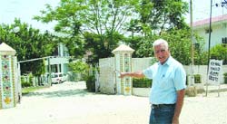 Malook Singh points to the newly repaired road inside the gate of Kewal Vihar colony in Jalandhar