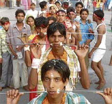 IT'S A MATTER OF FAITH: Devotees of Seetla Mata with pierce their cheeks to please the Godess in Ludhiana on Thursday.