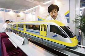 A Chinese engineer shows a locally designed electric train at a hitech expo in Beijing on Friday. Radiation fears have prompted China to shelve a $4.3-billion extension of its high-speed magnetic levitation train in Shanghai, amid concerns the German technology could contaminate residents.