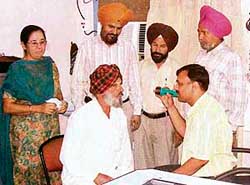 An ophthalmologist examines a patient at an eye care camp in Anand Isher Senior Secondary School, Ahmedgarh