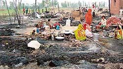 Shantinagar residents try to salvage some articles from the ashes