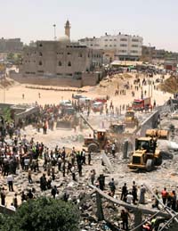Palestinians inspect a damaged compound used by Hamass Executive Force after an Israeli air strike in Gaza on Saturday. Israel pounded Hamas positions in Gaza Strip, killing four fighters. 