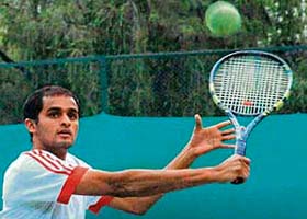 Varun Walia of STA Dehradun plays a shot during the qualifying round match of the ITF Mens Future Circuit tennis meet at CLTA in Chandigarh