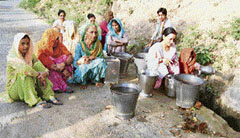 Women wait for their turn to fill water.