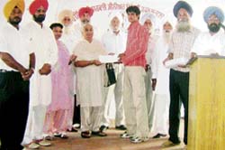 A student receives a prize at the annual function of the Kartar Singh Dukki Government Senior Secondary School, Latala, near Ahmedgarh