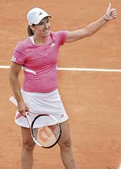 Belgiums Justine Henin celebrates after beating Russias Elena Vesnina in the first round of the French Open in Paris on Sunday. Henin won 6-4, 6-3.