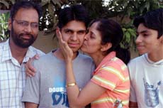 WE ARE PROUD OF YOU: Topper Dilsher Bhagal with his parents in Jalandhar.
